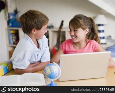 Boy And Girl Doing Their Homework On A Laptop