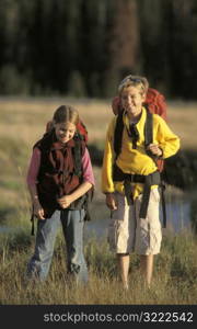 Boy and Girl Hiking Across the Plain