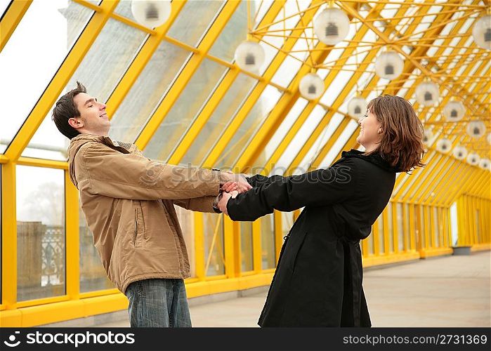 boy and girl hold each other for hands