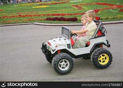 boy and girl in toy car
