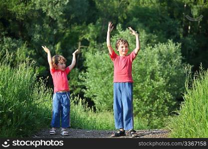 boy and girl make gymnastic in park