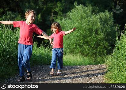 boy and girl make gymnastic in park
