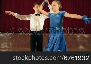 boy and girl of 9 years dancing the jive in the ballroom. DOF