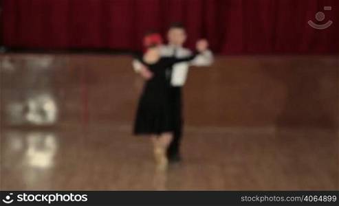 boy and girl of 9 years dancing the Tango in the ballroom. DOF