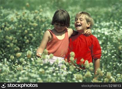 Boy and Girl Playing in a Field