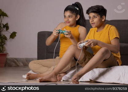 Boy and girl playing video games in living room at home