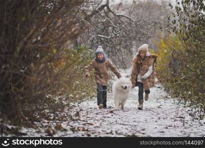 Boy and girl running a race with the Samoyed.. Children run the race with his beloved dog 9848.