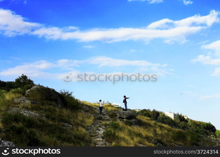 Boy and girl standing on the mountain