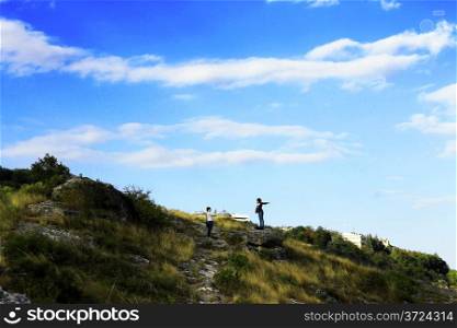 Boy and girl standing on the mountain