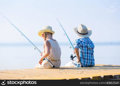 Boy and girl with fishing rods. Boy and girl with fishing rods fishing together from a pier