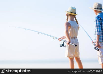 Boy and girl with fishing rods. Boy and girl with fishing rods fishing together from a pier