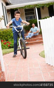 Boy and grandfather at home with bike