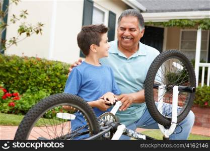 boy and grandfather fixing bike