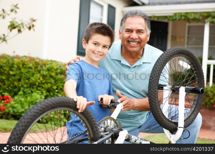 boy and grandfather fixing bike