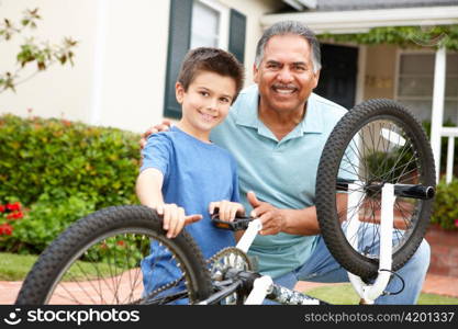 boy and grandfather fixing bike