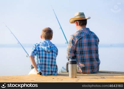 boy and his father fishing togethe. boy and his father fishing together from a pier