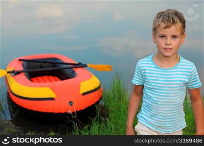 boy and inflatable boat ashore