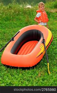boy and inflatable boat on lawn
