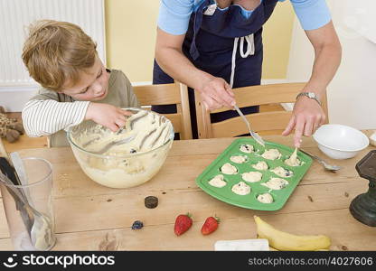 boy and mum making fruit muffins