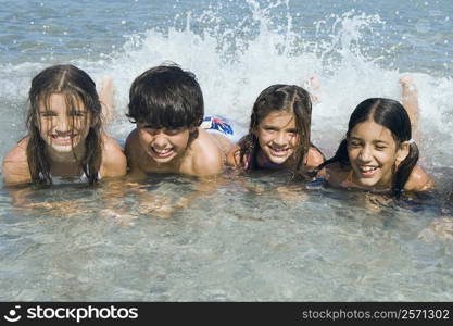 Boy and three girls swimming in the sea