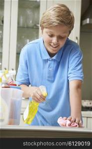 Boy At Home Helping to Clean Kitchen
