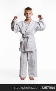 Boy athlete is fond of judo and does warm-up hands