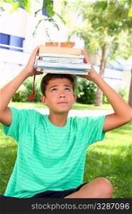 Boy balancing books on his head