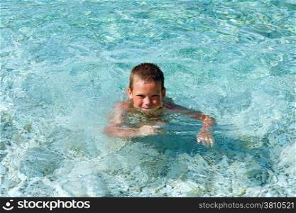 Boy bathing in the sea. Summer vacation (Greece, Kefalonia).