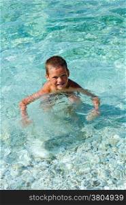 Boy bathing in the sea. Summer vacation (Greece, Kefalonia, Beach Antisamos).
