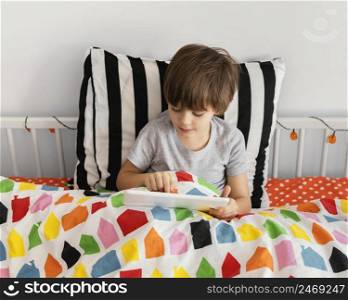 boy bed with tablet