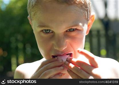 Boy biting into food