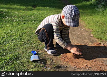 boy builds sand house