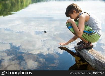Boy by a lake