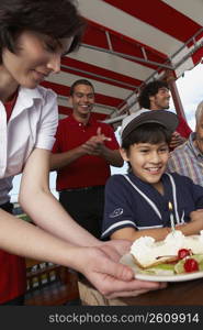 Boy celebrating his birthday with his grandfather in a restaurant