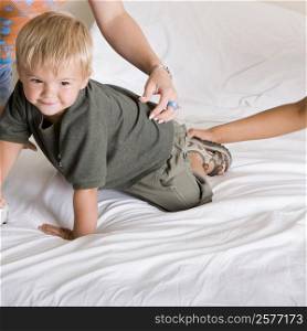 Boy crawling on a bed