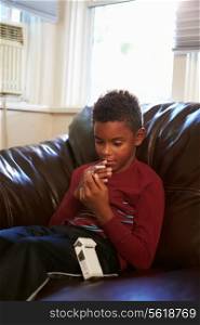 Boy Discovering Parent&#39;s Pack Of Cigarettes At Home