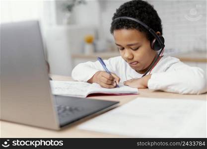 boy doing homework with use laptop