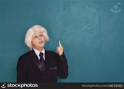 Boy dressed as Einstein thinking