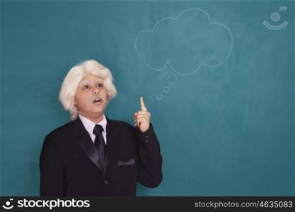 Boy dressed as Einstein thinking