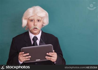 Boy dressed as Einstein with digital tablet