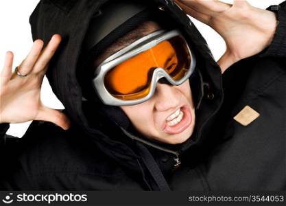 Boy dressed in snowboarding suit and helmet and googles reacting surprised on something he sees. Studio shot.