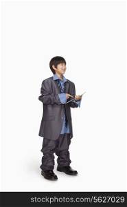 Boy dressed up as businessman using tablet