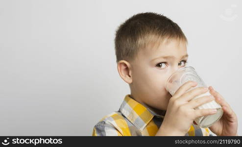 boy drinking milk with glass