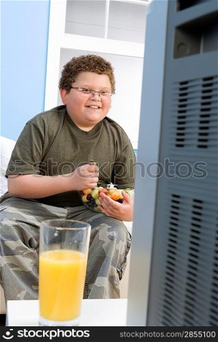 Boy Eating Bowl of Fruit