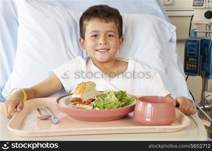 Boy Eating Meal In Hospital Bed