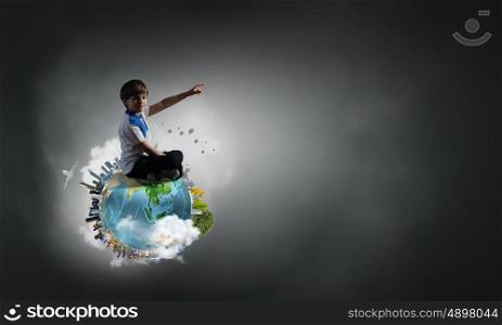 Boy exploring world. Cute school boy sitting on Earth planet and pointing with finger up. Elements of this image are furnished by NASA
