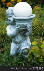 boy garden decorative statue on green grass