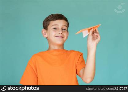 boy getting ready throw paper airplane