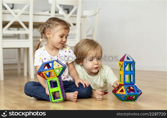 boy girl home playing with toys together