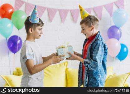 boy giving birthday gift his friend